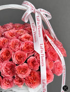 Close-up of Blush Royale pink roses and LaFia Flowers ribbon