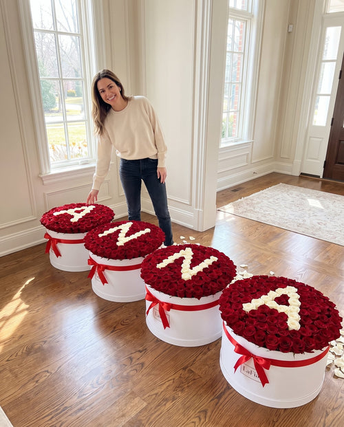 Four custom rose boxes spelling ANNA shown with a person for scale - LaFia Flowers