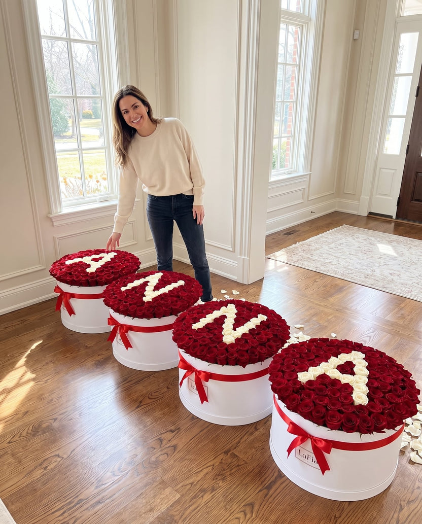 Four custom rose boxes spelling ANNA shown with a person for scale - LaFia Flowers