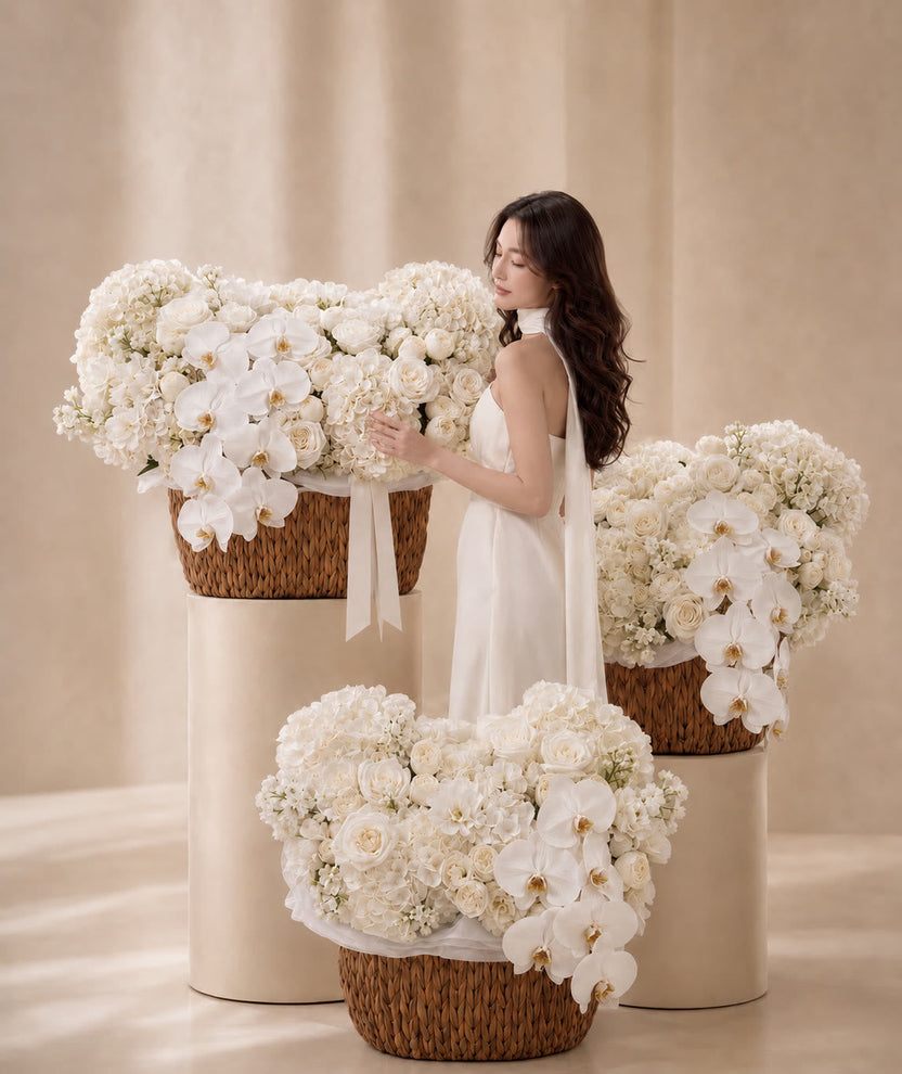 White hydrangeas, roses and cascading orchids in an ivory basket - LaFia Flowers