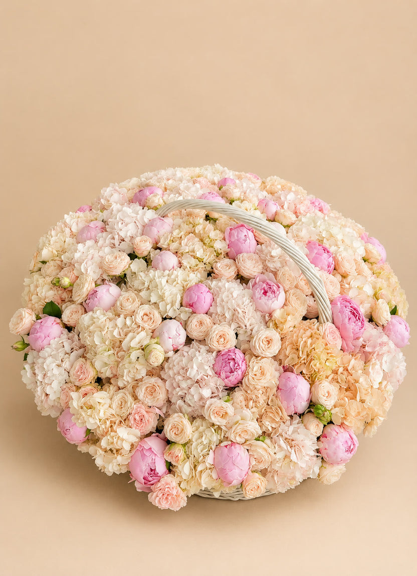Peach peonies and hydrangeas in a pastel cloud basket - LaFia Flowers