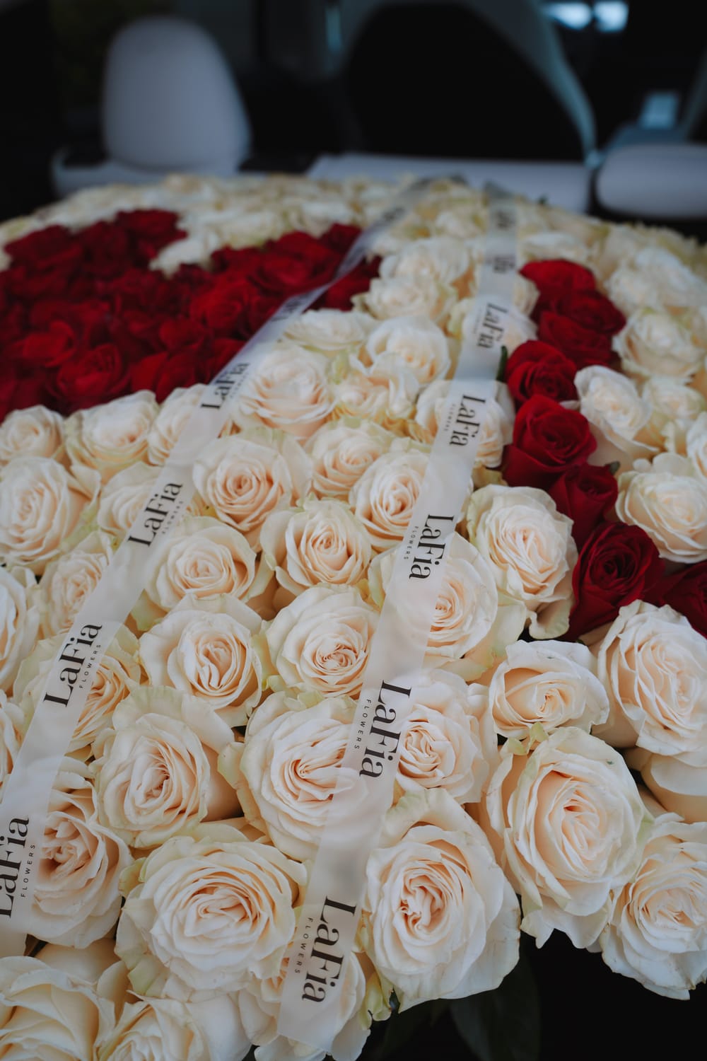Close detail of real white and red roses arranged by LaFia